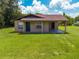 Charming single-story home featuring a covered porch and a well-manicured lawn at 431 Eastern Ave, St Cloud, FL 34769