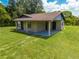 Charming single-story home with a covered front porch and lush green lawn at 431 Eastern Ave, St Cloud, FL 34769