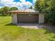 Oversized two-car garage featuring a traditional metal roof and panel garage doors at 431 Eastern Ave, St Cloud, FL 34769