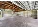 Open garage revealing exposed wood ceiling, concrete block wall, and built in shelving at 431 Eastern Ave, St Cloud, FL 34769