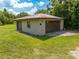 Spacious two-car garage with a rustic metal roof surrounded by a green lawn at 431 Eastern Ave, St Cloud, FL 34769