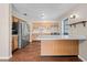 Kitchen showcasing wood cabinetry, stainless steel refrigerator, and a breakfast bar, with modern appliances at 431 Eastern Ave, St Cloud, FL 34769
