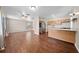 Bright kitchen featuring wood cabinets, stainless steel refrigerator, and breakfast bar, adjacent to the living area at 431 Eastern Ave, St Cloud, FL 34769