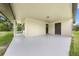 Covered patio area with neutral tones, offering a versatile outdoor space, and dual entrances at 431 Eastern Ave, St Cloud, FL 34769