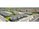 Aerial view of a vibrant residential community featuring a lake, walking trails, and modern townhomes at 4850 Coral Castle Dr, Kissimmee, FL 34746