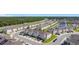 An aerial view of townhomes, a pond, and green space in the residential community of Fiesta Key at 4850 Coral Castle Dr, Kissimmee, FL 34746