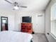 Bedroom featuring a ceiling fan, TV, and dresser at 4850 Coral Castle Dr, Kissimmee, FL 34746