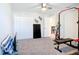 Bright bedroom with a ceiling fan, and workout equipment at 4850 Coral Castle Dr, Kissimmee, FL 34746