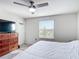Bedroom featuring a ceiling fan, TV, and dresser at 4850 Coral Castle Dr, Kissimmee, FL 34746