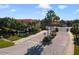Gated community entrance features mature palm trees and lush landscaping at 4850 Coral Castle Dr, Kissimmee, FL 34746