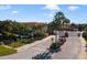 Community entrance with sign and palm trees at 4850 Coral Castle Dr, Kissimmee, FL 34746