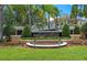 The community entrance features lush landscaping and decorative signage at 4850 Coral Castle Dr, Kissimmee, FL 34746