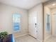 Bright entryway with tile floors, neutral walls, and a front door with secure access at 4850 Coral Castle Dr, Kissimmee, FL 34746