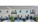 Exterior shot of Fiesta Key townhomes showcasing neutral colors, maintained landscaping, and inviting entrances at 4850 Coral Castle Dr, Kissimmee, FL 34746