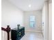 A bright foyer features a decorative cabinet, tiled floor, and a sunlit window above the cabinet at 4850 Coral Castle Dr, Kissimmee, FL 34746