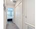 Bright hallway featuring carpeted floor, closet doors and a bedroom at the end of the hall at 4850 Coral Castle Dr, Kissimmee, FL 34746