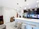 Spacious kitchen with a large island, modern pendant lighting, and stainless steel appliances at 4850 Coral Castle Dr, Kissimmee, FL 34746