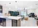 Open concept living area with a kitchen island, tiled floors, and contemporary decor at 4850 Coral Castle Dr, Kissimmee, FL 34746