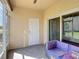 Covered patio with tile flooring, doorway access to the rest of the house and a sofa set at 4850 Coral Castle Dr, Kissimmee, FL 34746