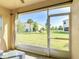 Outside patio with large sliding glass screen, showcasing a view of the community at 4850 Coral Castle Dr, Kissimmee, FL 34746