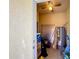 A storage room is packed with shelves and storage containers, with ceiling fan and a hot water heater at 4850 Coral Castle Dr, Kissimmee, FL 34746