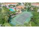 Aerial view showcasing the tennis courts alongside the pool area and clubhouse for an active lifestyle at 4850 Coral Castle Dr, Kissimmee, FL 34746