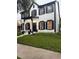 Well-maintained two-story home featuring a manicured lawn and inviting entrance at 5231 Lemon Twist Ln, Windermere, FL 34786