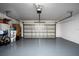 Clean and organized garage space with epoxy floor, offering ample room for parking and storage at 5231 Lemon Twist Ln, Windermere, FL 34786