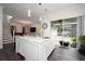 Open kitchen concept features white marble island with seating, flowing to the living and outside spaces at 5231 Lemon Twist Ln, Windermere, FL 34786
