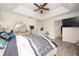Spacious main bedroom featuring tray ceiling, wood floors, decorative mirror, and ensuite bathroom at 5231 Lemon Twist Ln, Windermere, FL 34786