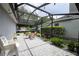 Covered and screened patio area, perfect for outdoor entertaining and relaxation with stone flooring at 5231 Lemon Twist Ln, Windermere, FL 34786