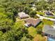 Aerial view of the property shows the home nestled among lush greenery and other homes at 640 Floridian Dr, Kissimmee, FL 34758