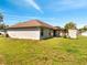 Expansive backyard featuring a covered patio area, offering ample space for outdoor activities at 640 Floridian Dr, Kissimmee, FL 34758