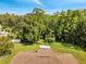 Aerial view of a fenced backyard with lush greenery and mature trees surrounding the property at 640 Floridian Dr, Kissimmee, FL 34758