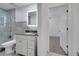 Bathroom with vanity, lighted mirror, tiled shower, and open door leading to bedroom at 640 Floridian Dr, Kissimmee, FL 34758