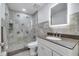 Bathroom with vanity, granite counters, tiled shower, and modern lighting at 640 Floridian Dr, Kissimmee, FL 34758