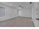 Spacious bedroom offers natural light with ceiling fan, wood-style floors, and white walls at 640 Floridian Dr, Kissimmee, FL 34758