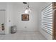 Bright dining area features white tile flooring, modern lighting, and stylish window blinds at 640 Floridian Dr, Kissimmee, FL 34758