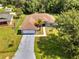 Aerial view of a single Gathering home with an attached garage and a palm tree in the front yard at 640 Floridian Dr, Kissimmee, FL 34758