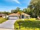 Inviting single-story home with manicured lawn and mature palm tree at 640 Floridian Dr, Kissimmee, FL 34758