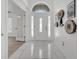 Bright foyer with tiled flooring and a contemporary white door at 640 Floridian Dr, Kissimmee, FL 34758