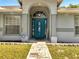Front door has an arched entryway and decorative glass at 640 Floridian Dr, Kissimmee, FL 34758