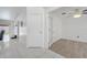 Bright hallway with tiled flooring leading to a bedroom with wood flooring at 640 Floridian Dr, Kissimmee, FL 34758