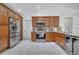 Kitchen with stainless steel appliances, wood cabinets, and granite countertops at 640 Floridian Dr, Kissimmee, FL 34758