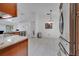 Kitchen with granite countertops, tile floors, stainless steel appliances, and wood cabinets at 640 Floridian Dr, Kissimmee, FL 34758