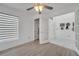 Bright living room featuring wood floors, fan, blinds, closet, and entry to the home at 640 Floridian Dr, Kissimmee, FL 34758
