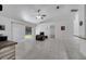 Spacious living room with white tile flooring, sliding glass door, and a ceiling fan at 640 Floridian Dr, Kissimmee, FL 34758