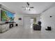Living room with tile floors, fireplace, flatscreen tv, and sliding glass doors to the backyard at 640 Floridian Dr, Kissimmee, FL 34758