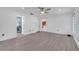 Open layout of the primary bedroom leading to a bathroom and featuring hardwood floors and neutral decor at 640 Floridian Dr, Kissimmee, FL 34758