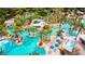 Lush tropical resort featuring multiple pools, lounging areas, and mature palm trees at 7770 Sandy Ridge Dr # 142, Kissimmee, FL 34747